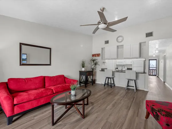 a living room with furniture and kitchen view