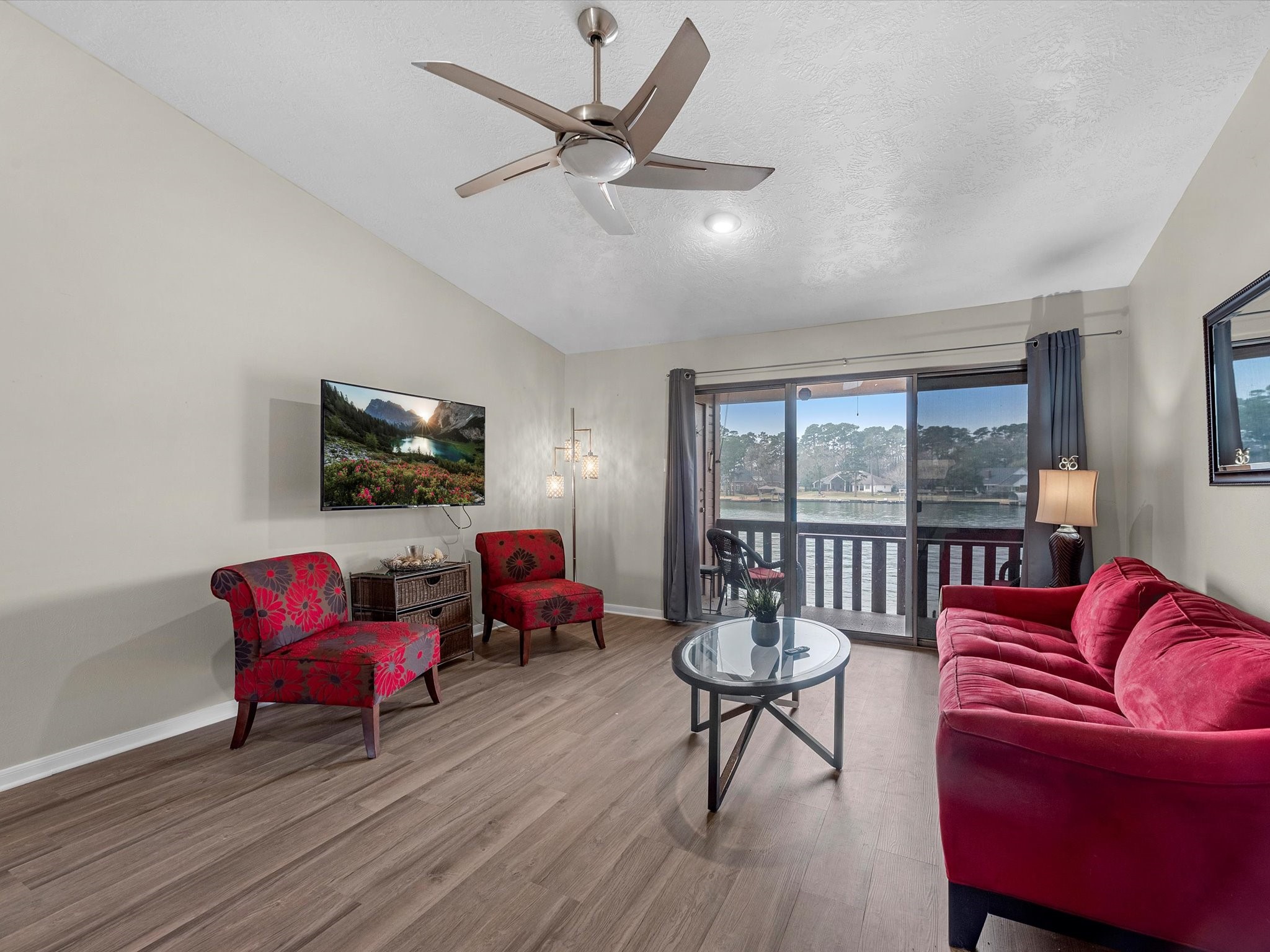 801 River Road, Unit 114F Montgomery, TX 77356 - Photo 5 of 25 a living room with furniture a flat screen tv and a large window