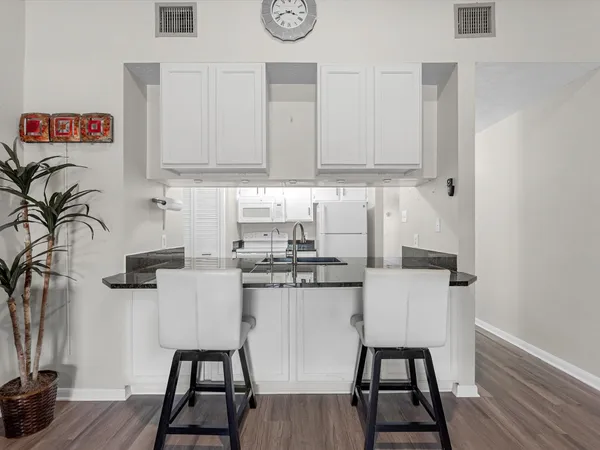 a kitchen with stainless steel appliances granite countertop a sink and cabinets