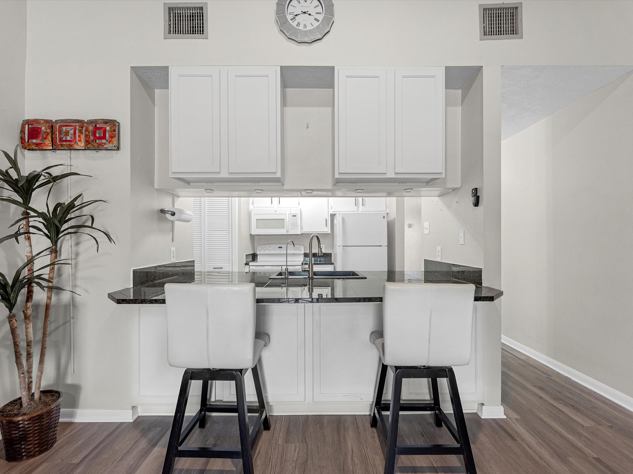 801 River Road, Unit 114F Montgomery, TX 77356 - Photo 7 of 25 a kitchen with stainless steel appliances granite countertop a sink and cabinets