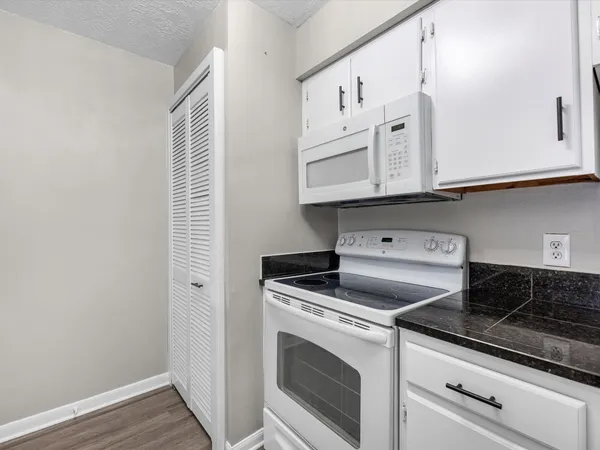 a kitchen with cabinets and appliances