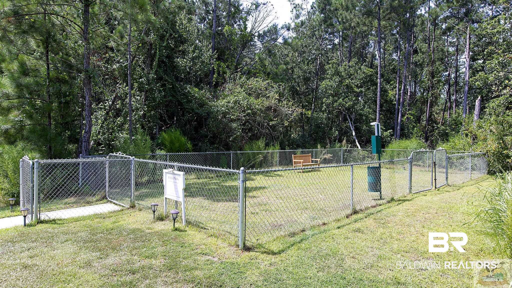 12489 Gateway Drive Elberta, AL 36530 - Photo 47 of 55 Surrounding community featuring a gate, a lawn, and fence