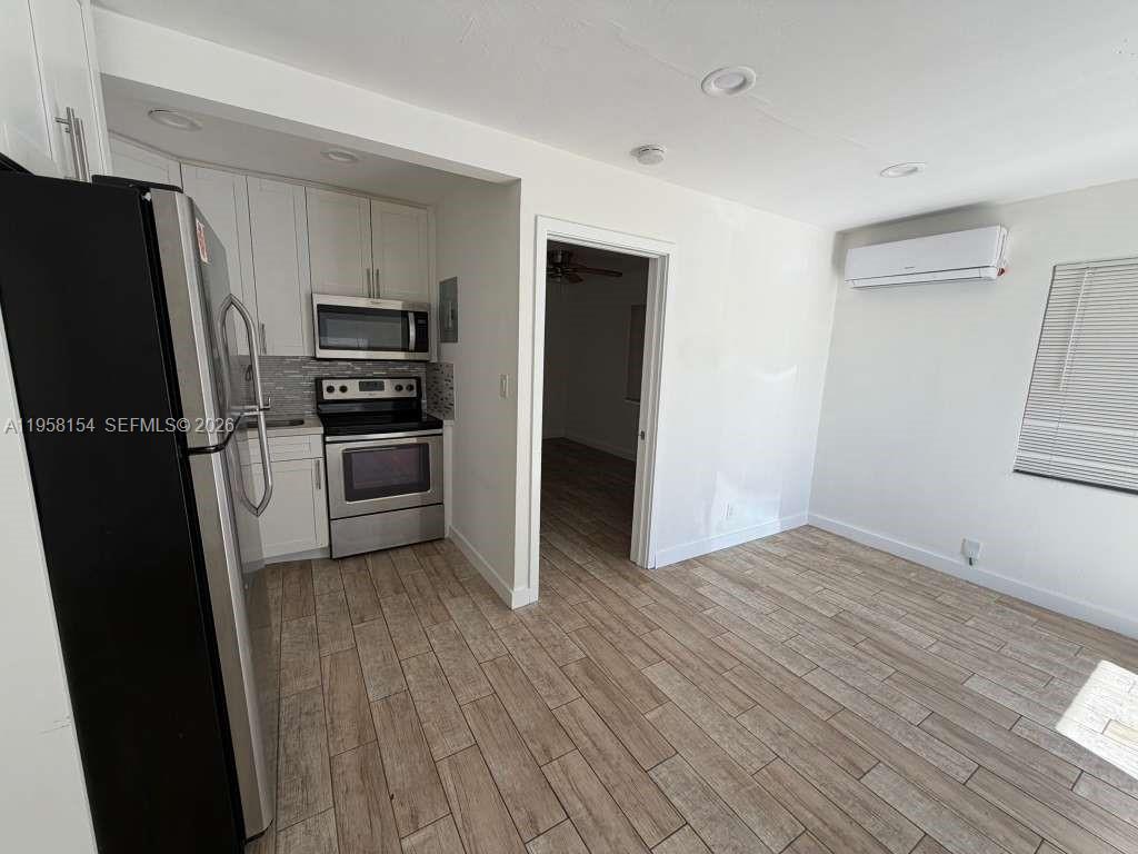 a kitchen with a refrigerator and a sink