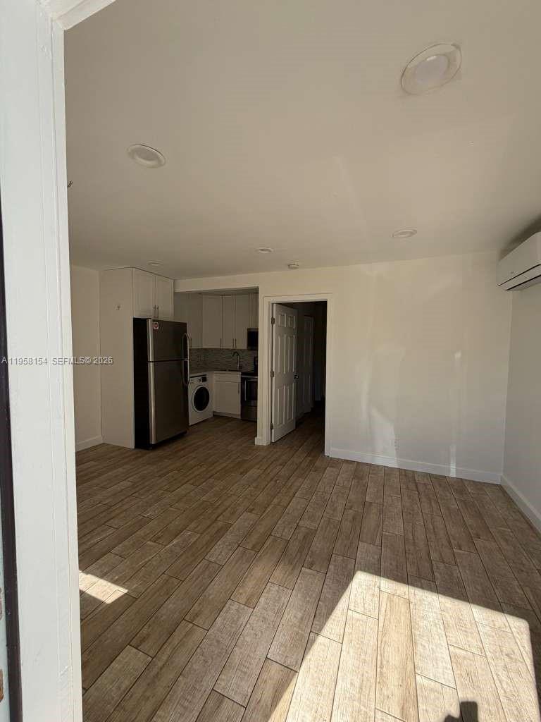 5843 Harding Street, Unit 12 Hollywood, FL 33021 - Photo 5 of 6 a view of empty room with wooden floor