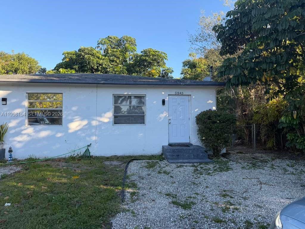 5843 Harding Street, Unit 12 Hollywood, FL 33021 - Photo 6 of 6 a front view of a house with garden