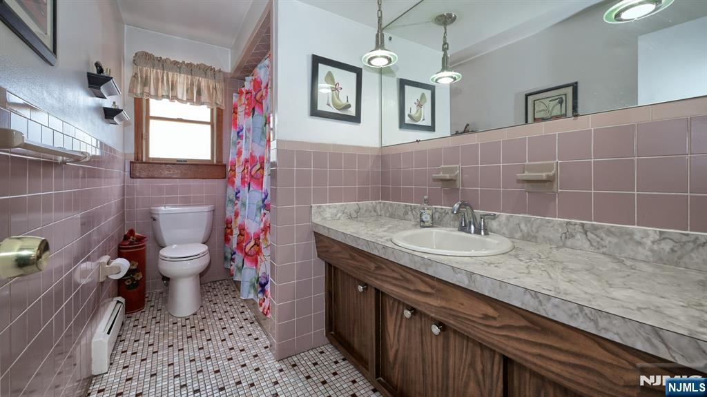 277 French Hill Road Wayne, NJ 07470 - Photo 19 of 28 a bathroom with a granite countertop sink a toilet and a mirror