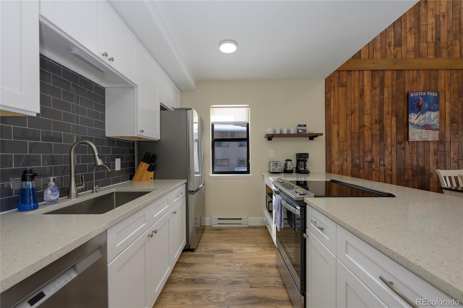 83 County Road, Unit F7 Fraser, CO 80442 - Photo 7 of 20 a kitchen with a sink and wooden cabinets