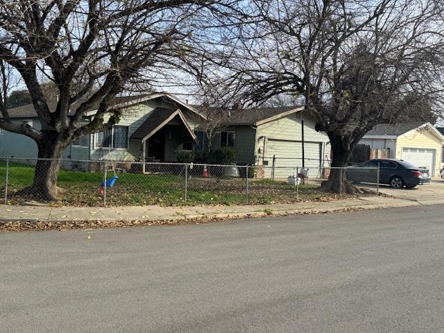 7315 Doc Adams Road Marysville, CA 95901 - Photo 2 of 3 a front view of a house with a yard and garage