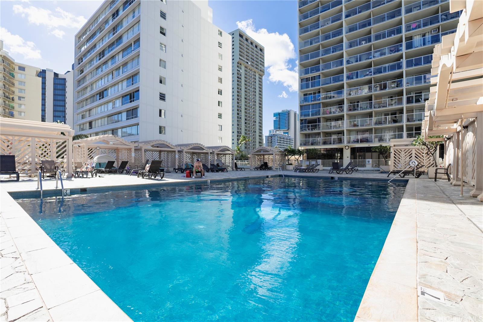 445 Seaside Avenue, Unit 2006 Honolulu, HI 96815 - Photo 11 of 23 a swimming pool with outdoor seating and yard