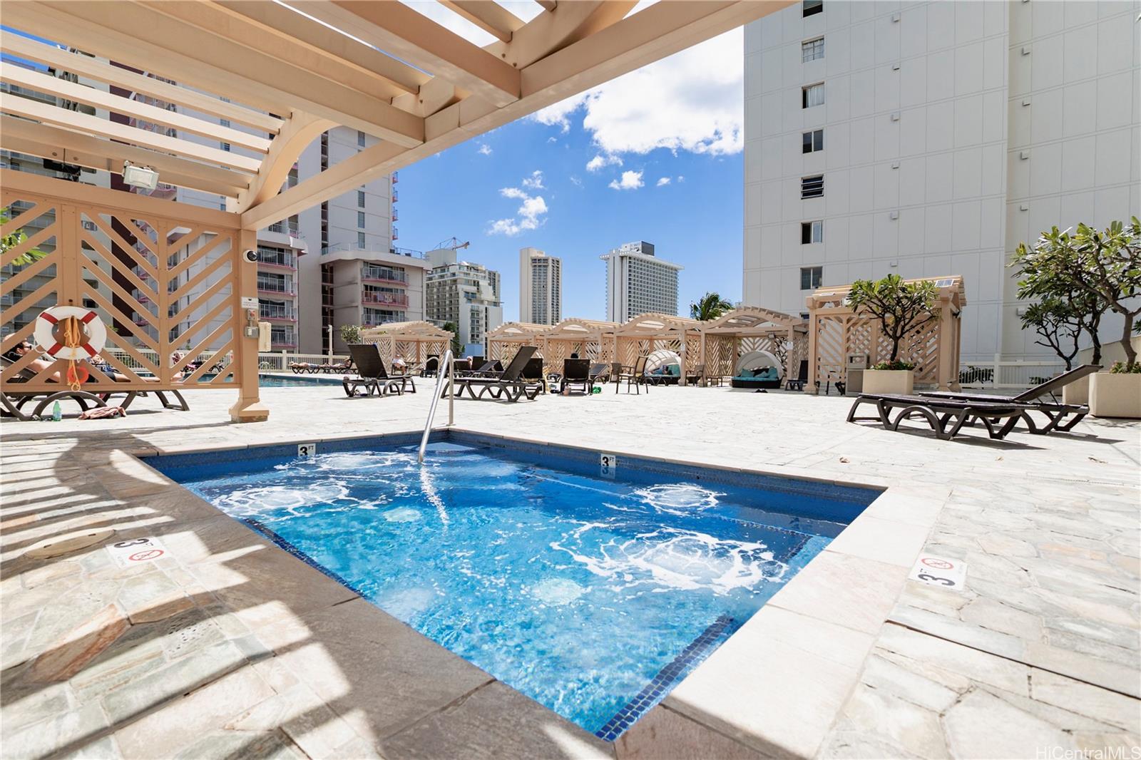 445 Seaside Avenue, Unit 2006 Honolulu, HI 96815 - Photo 14 of 23 a swimming pool with outdoor seating