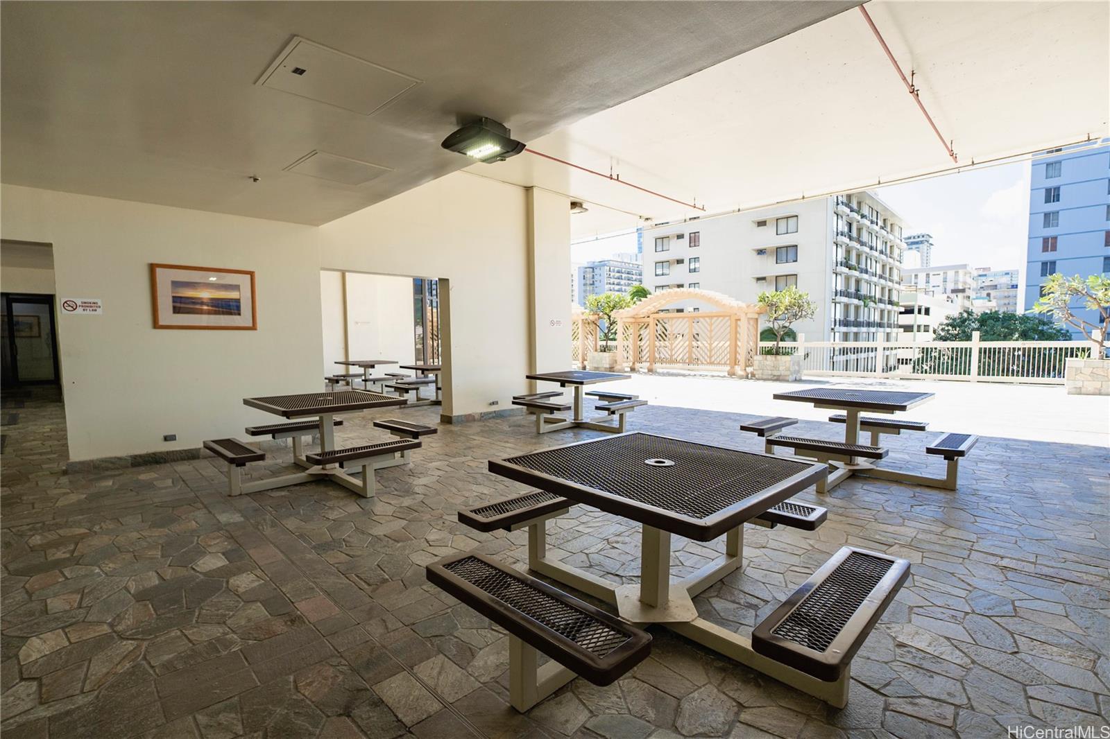 445 Seaside Avenue, Unit 2006 Honolulu, HI 96815 - Photo 18 of 23 a living room with furniture a rug and a floor to ceiling window
