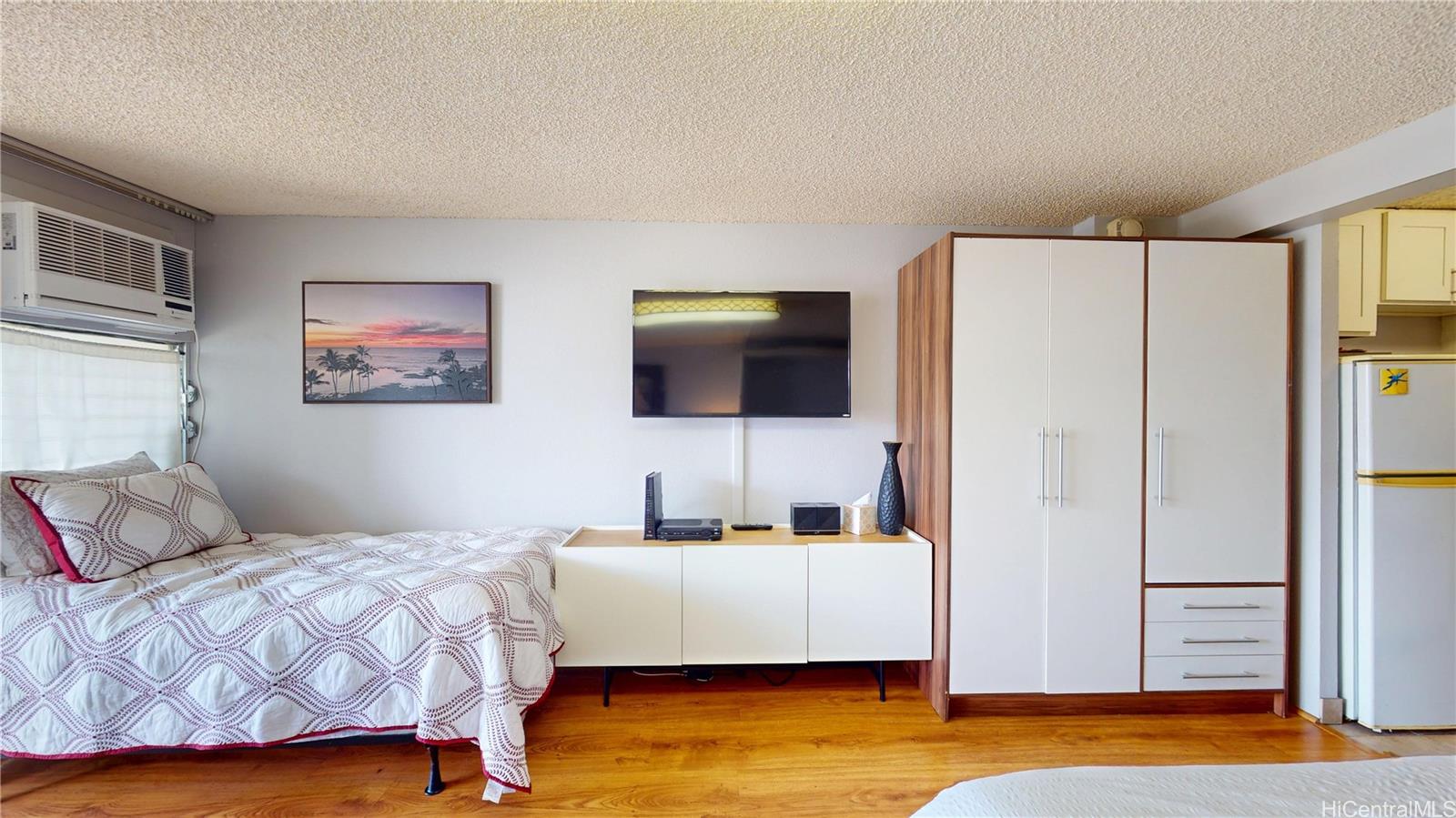 445 Seaside Avenue, Unit 2006 Honolulu, HI 96815 - Photo 3 of 23 a bedroom with a bed and a flat screen tv
