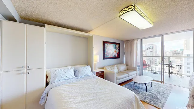 a bedroom with a large bed and a chandelier