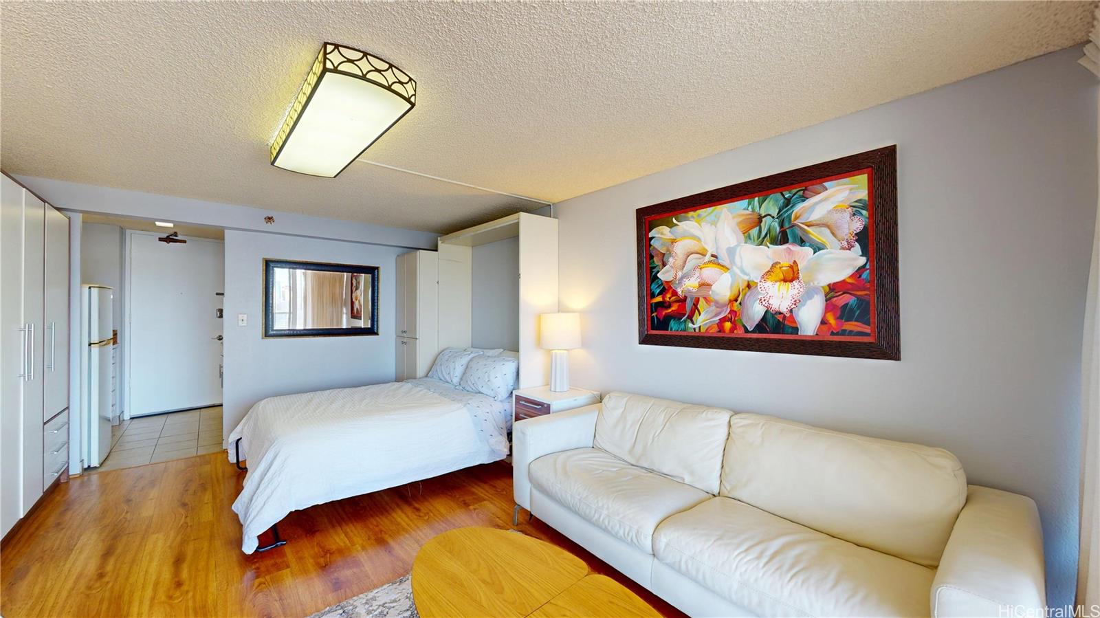 445 Seaside Avenue, Unit 2006 Honolulu, HI 96815 - Photo 5 of 23 a bedroom with a bed and a painting on the wall