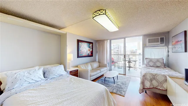 a bedroom with a bed a couch and a large window