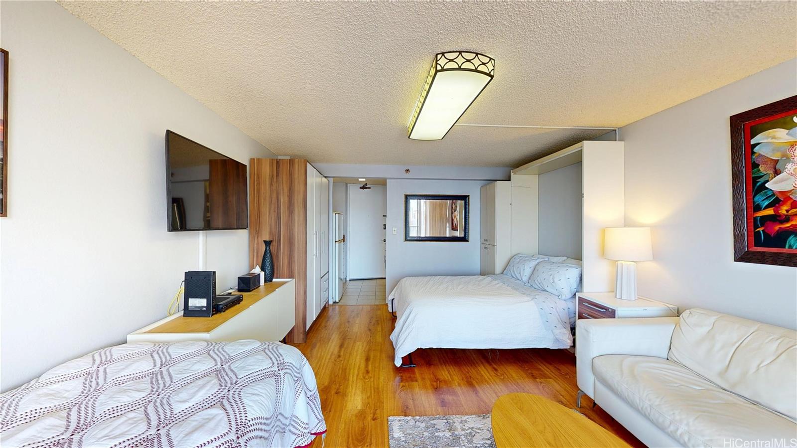 445 Seaside Avenue, Unit 2006 Honolulu, HI 96815 - Photo 7 of 23 a bedroom with a bed and a couch