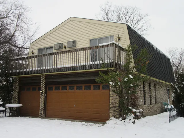 a backyard of a house with table and chairs