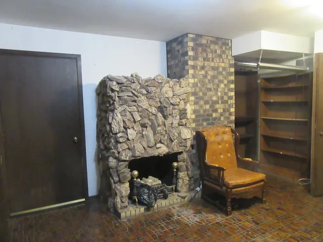 a room with a couch and a fireplace