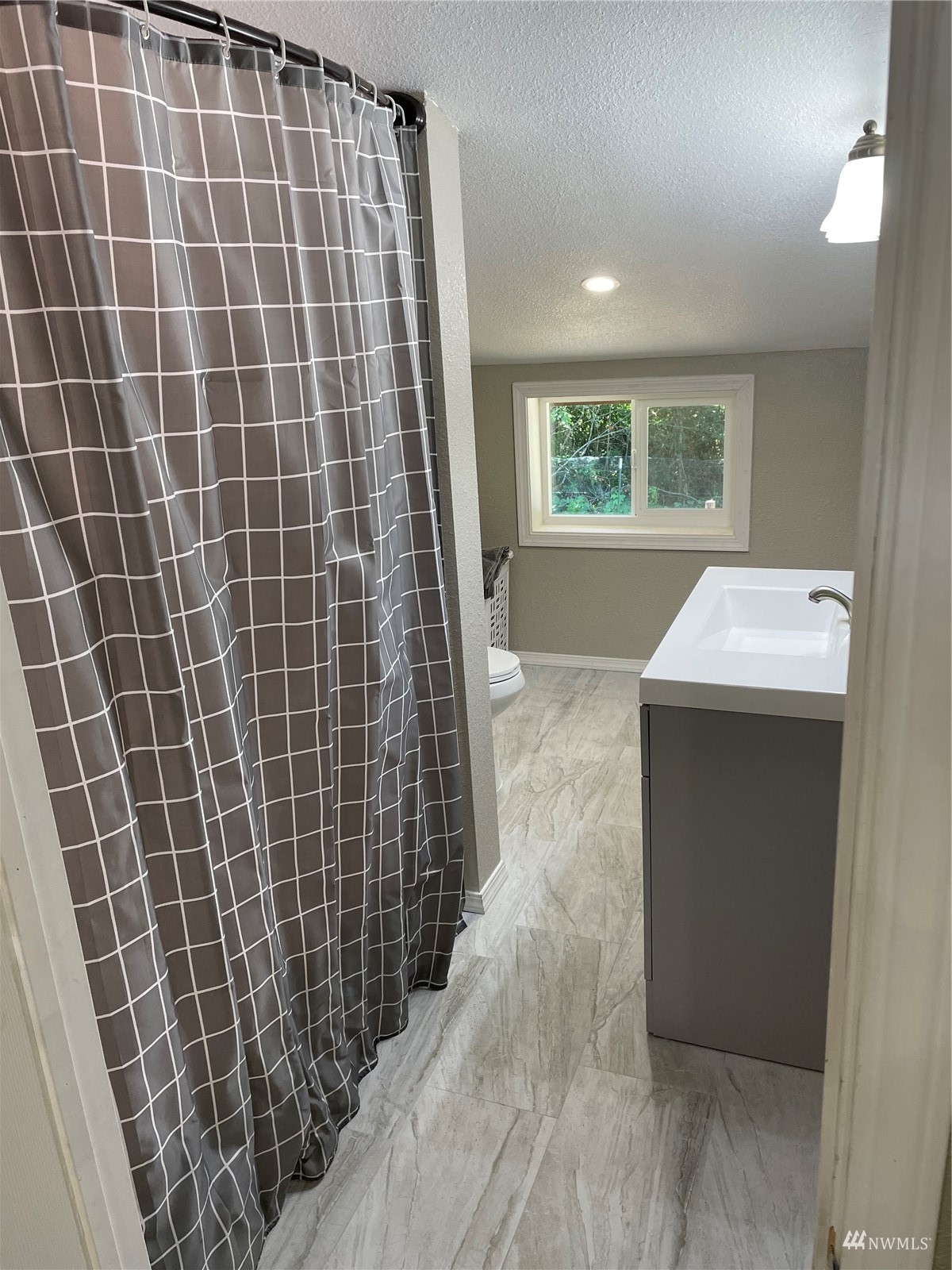 650-38 Logan Hill Road Chehalis, WA 98532 - Photo 24 of 36 a bathroom with a sink toilet and window