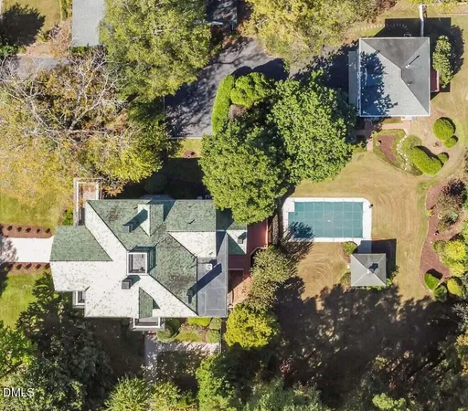 an aerial view of a house with a yard and garden