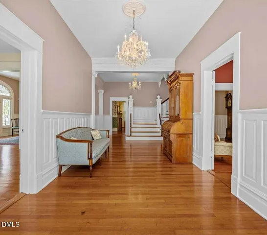 a view of walk in closet with wooden floor