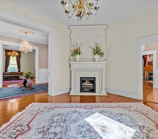 a kitchen with stainless steel appliances granite countertop a stove a sink dishwasher a dining table and chairs with wooden floor