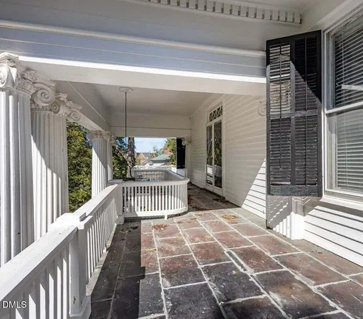 a kitchen with stainless steel appliances a dining table chairs and a microwave