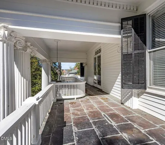 a kitchen with stainless steel appliances a dining table chairs and a microwave