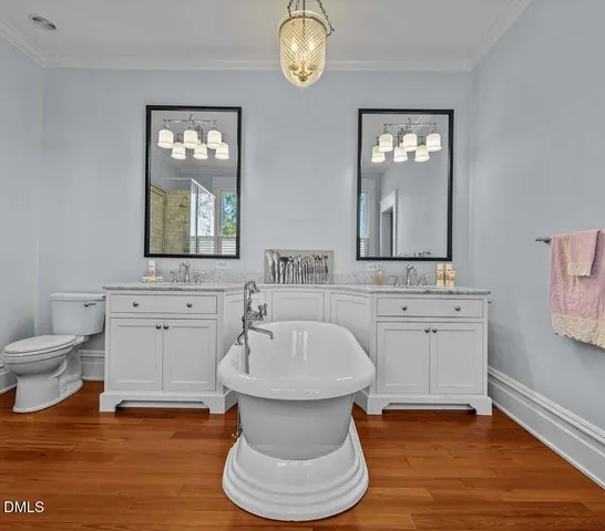 a front view of a house with yard and green space