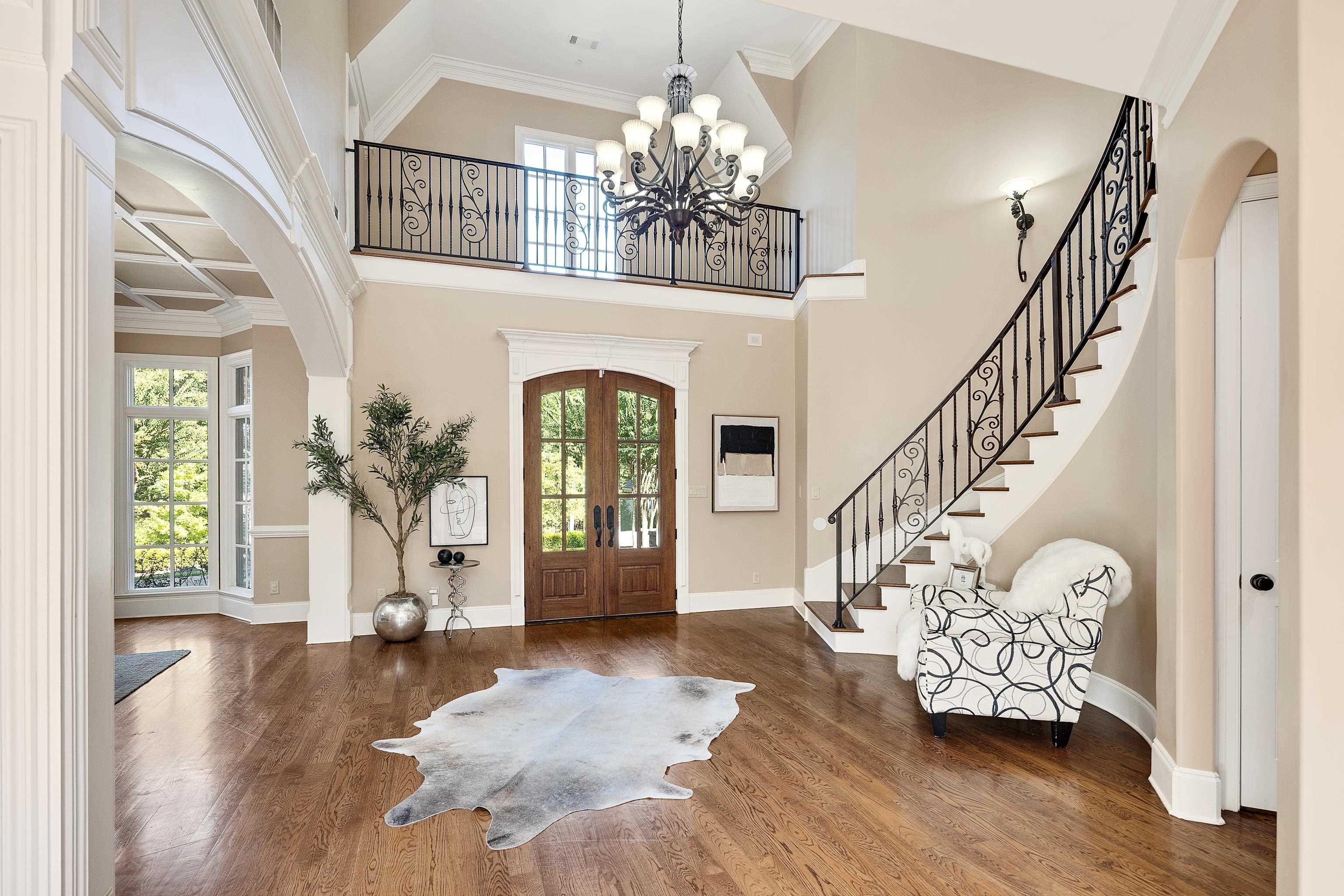 425 Buckland Cove Eads, TN 38028 - Photo 4 of 29 Foyer entrance with arched walkways, crown molding, french doors, wood finished floors, and a towering ceiling
