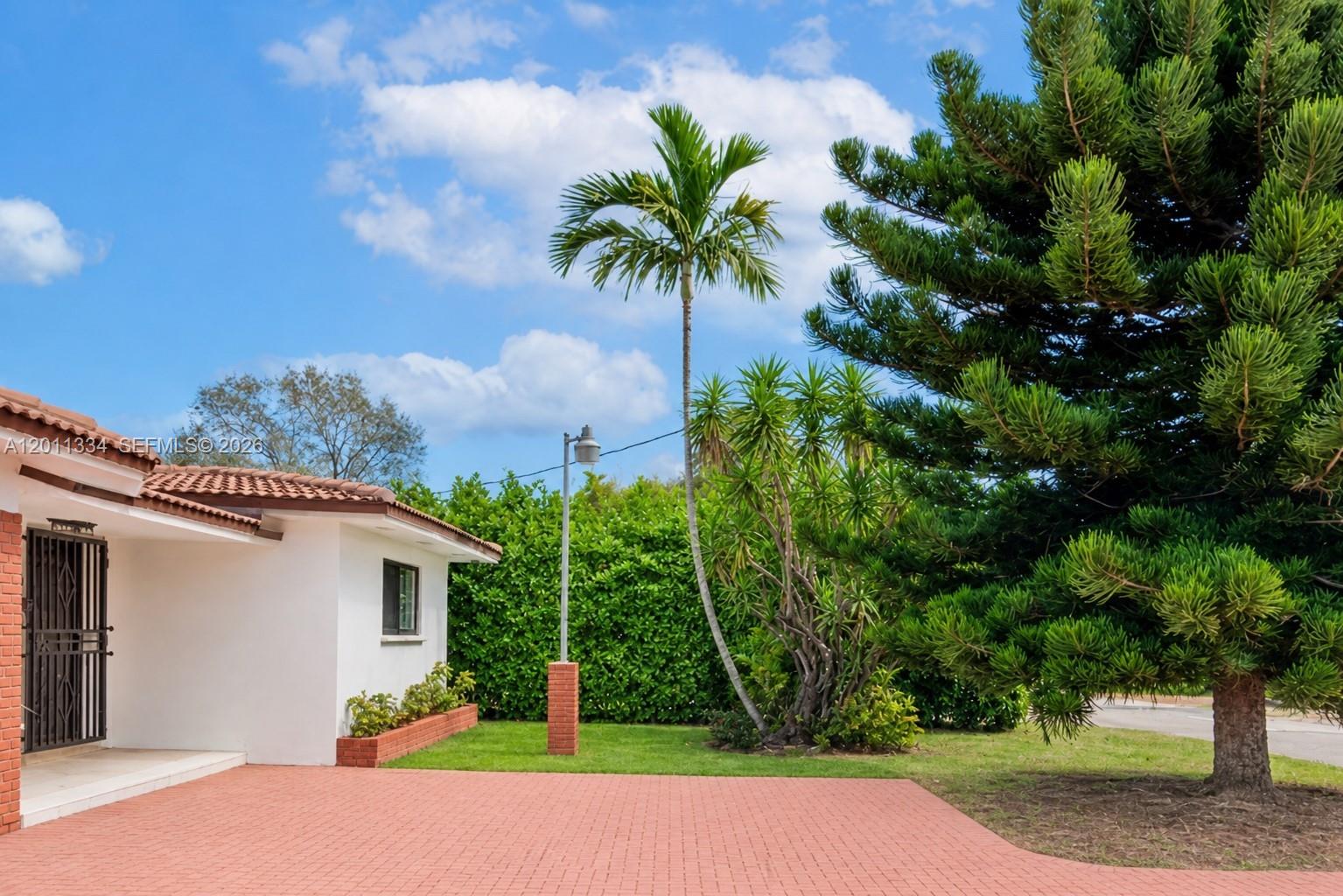 6385 Southwest 25th Street Miami, FL 33155 - Photo 3 of 28 a view of backyard of house with outdoor seating and green space