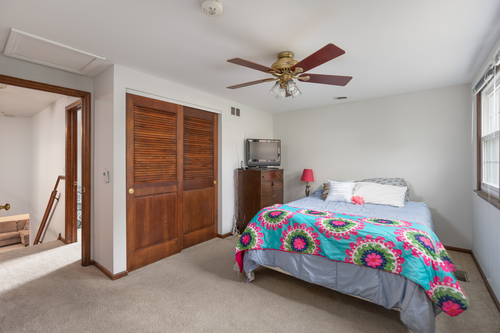 1616 Apache Drive Naperville, IL 60563 - Photo 22 of 36 a bedroom with a bed and a chandelier