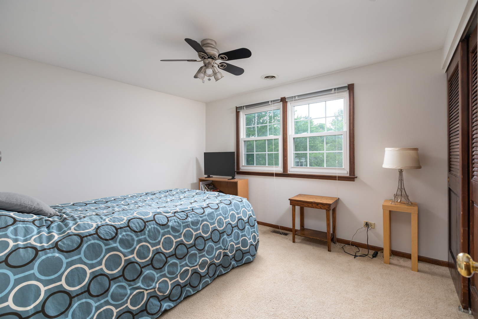 1616 Apache Drive Naperville, IL 60563 - Photo 25 of 36 a bedroom with a bed and a lamp next to a window