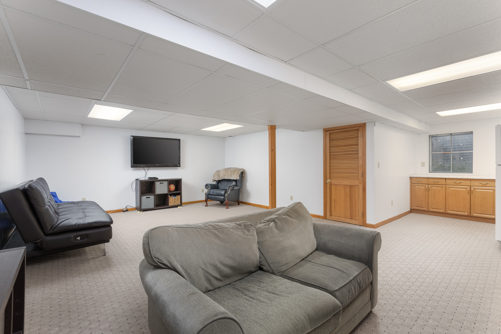 1616 Apache Drive Naperville, IL 60563 - Photo 27 of 36 a living room with furniture and a flat screen tv