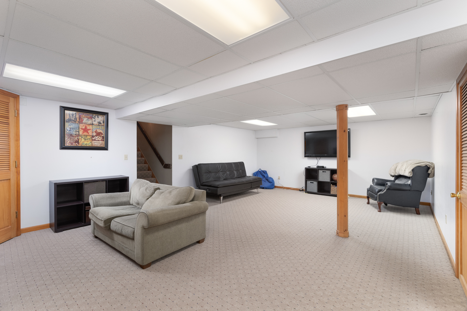 1616 Apache Drive Naperville, IL 60563 - Photo 28 of 36 a living room with furniture and a flat screen tv