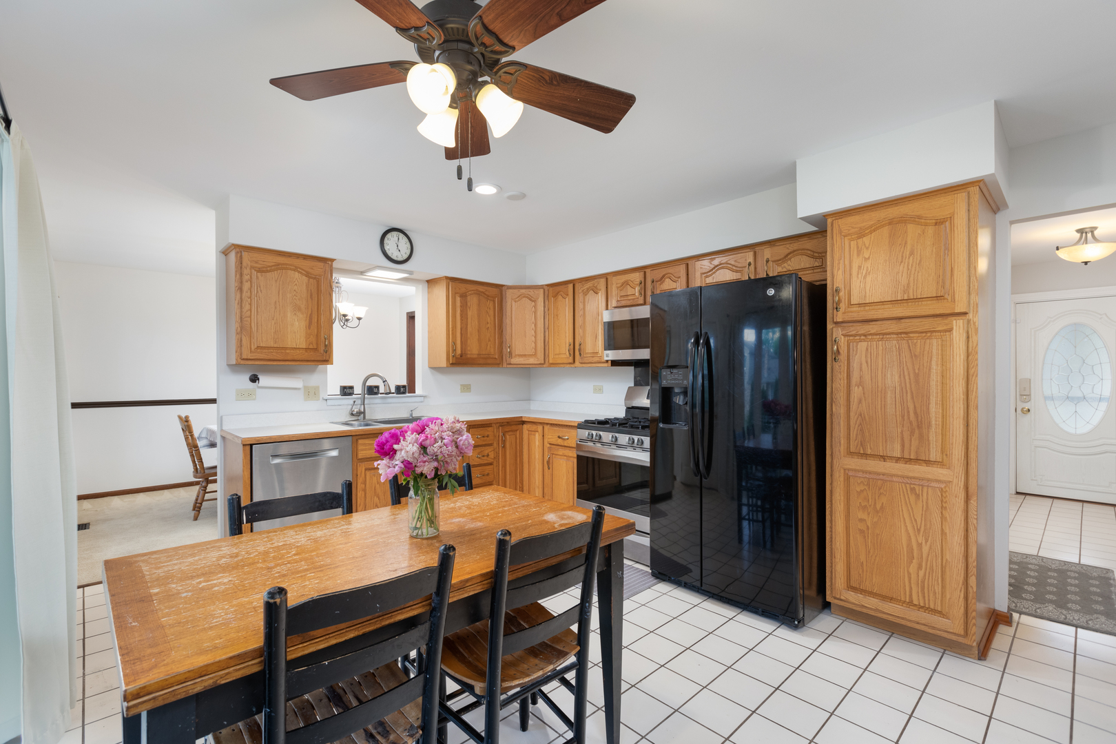 1616 Apache Drive Naperville, IL 60563 - Photo 6 of 36 a kitchen with stainless steel appliances refrigerator dining table and chairs