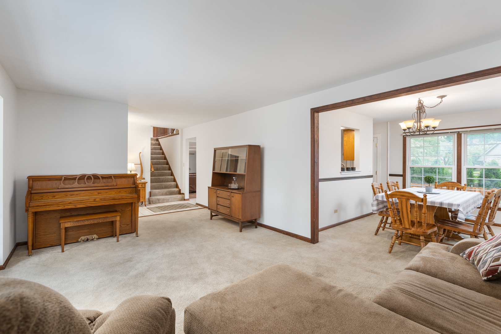 1616 Apache Drive Naperville, IL 60563 - Photo 9 of 36 a living room with furniture and a piano