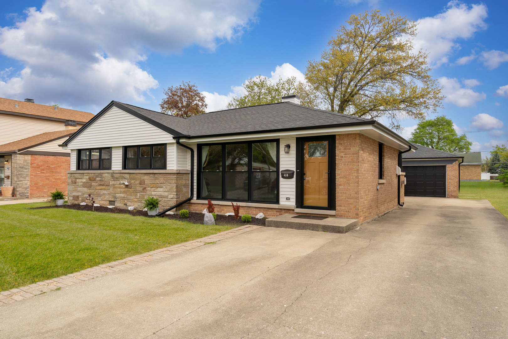 439 Highview Avenue Elmhurst, IL 60126 - Photo 3 of 42 a front view of a house with a garden and yard