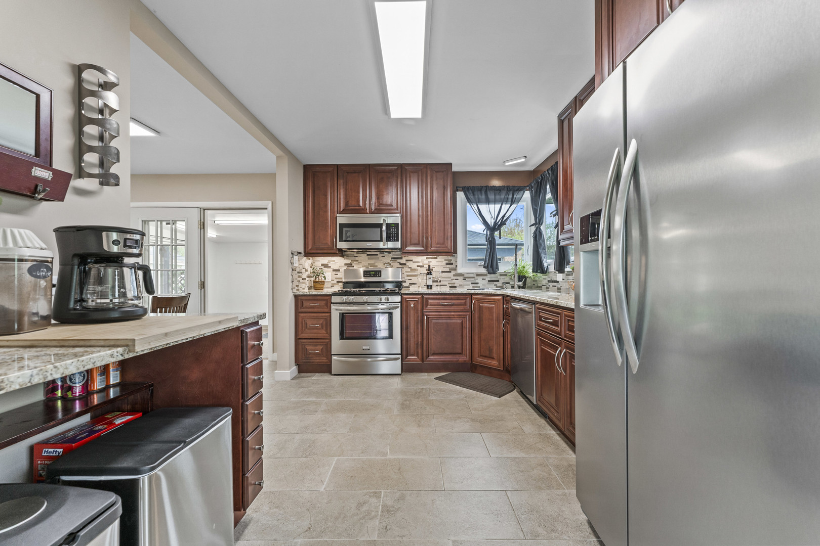 439 Highview Avenue Elmhurst, IL 60126 - Photo 8 of 42 a kitchen with stainless steel appliances a refrigerator sink and stove