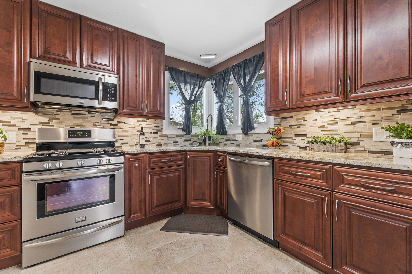 439 Highview Avenue Elmhurst, IL 60126 - Photo 9 of 42 a kitchen with stainless steel appliances granite countertop wooden cabinets a stove top oven a sink and dishwasher