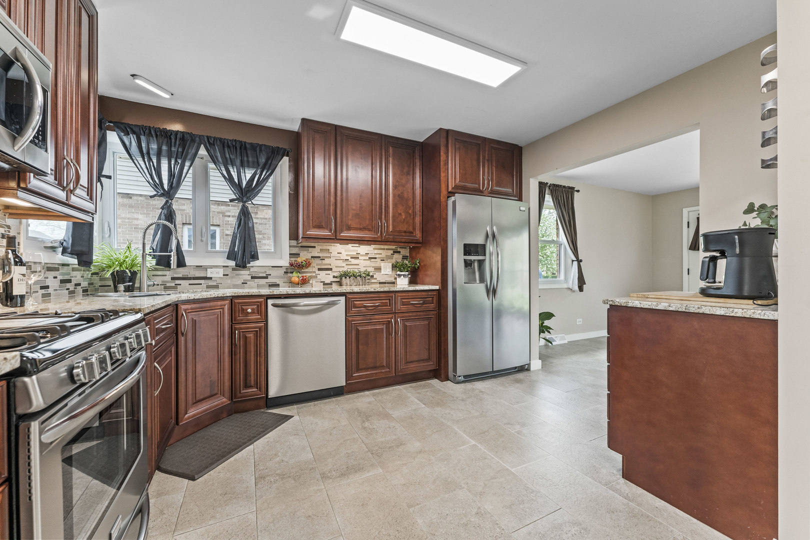 439 Highview Avenue Elmhurst, IL 60126 - Photo 10 of 42 a kitchen with stainless steel appliances granite countertop a stove a sink dishwasher a refrigerator and cabinets with wooden floor