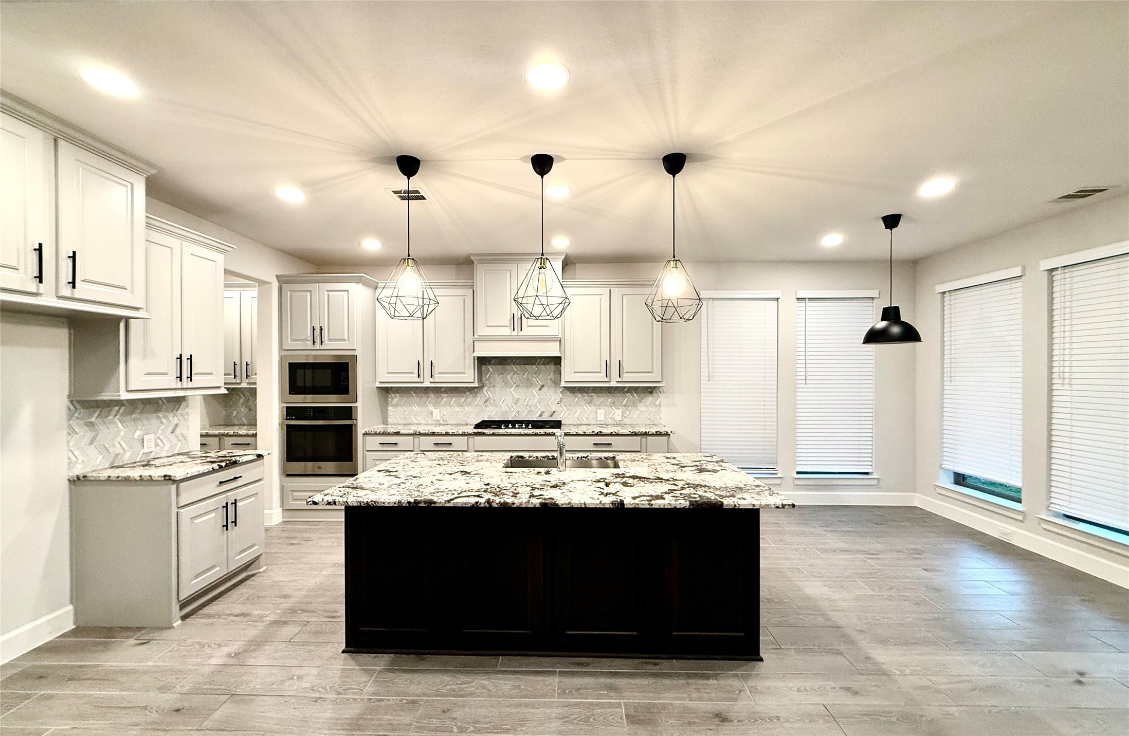 596 Santa Rosa Hls Drive Katy, TX 77493 - Photo 13 of 45 a kitchen with kitchen island granite countertop a stove a sink and a refrigerator
