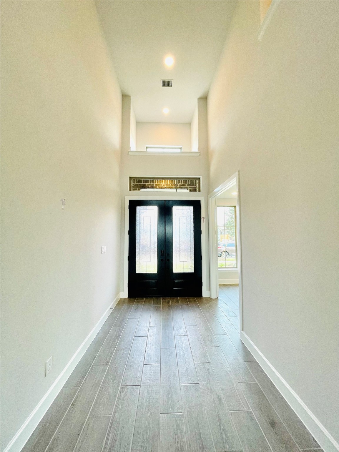 596 Santa Rosa Hls Drive Katy, TX 77493 - Photo 5 of 45 a view of an empty room with a window and wooden floor