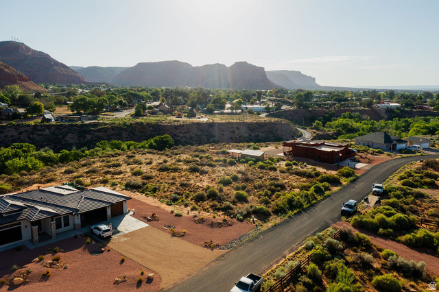 50 Dry Gulch Road, Unit 50 Kanab, UT 84741 - Photo 7 of 20 High-level aerial perspective showcasing mountain topography, distant residential areas, and expansive arid landscaping