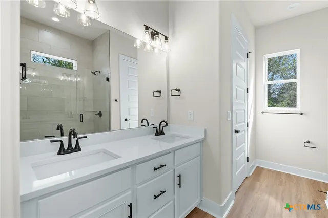 a bathroom with a sink a tub and a mirror