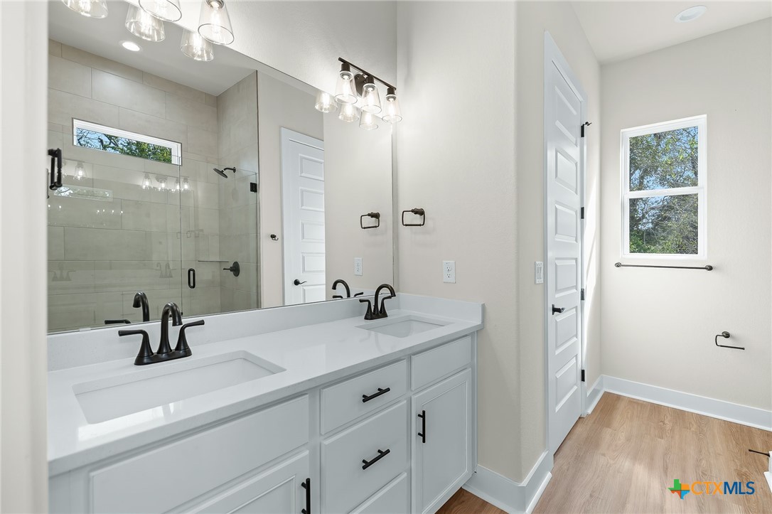223 Allen Street Bartlett, TX 76511 - Photo 16 of 21 a bathroom with a sink a tub and a mirror