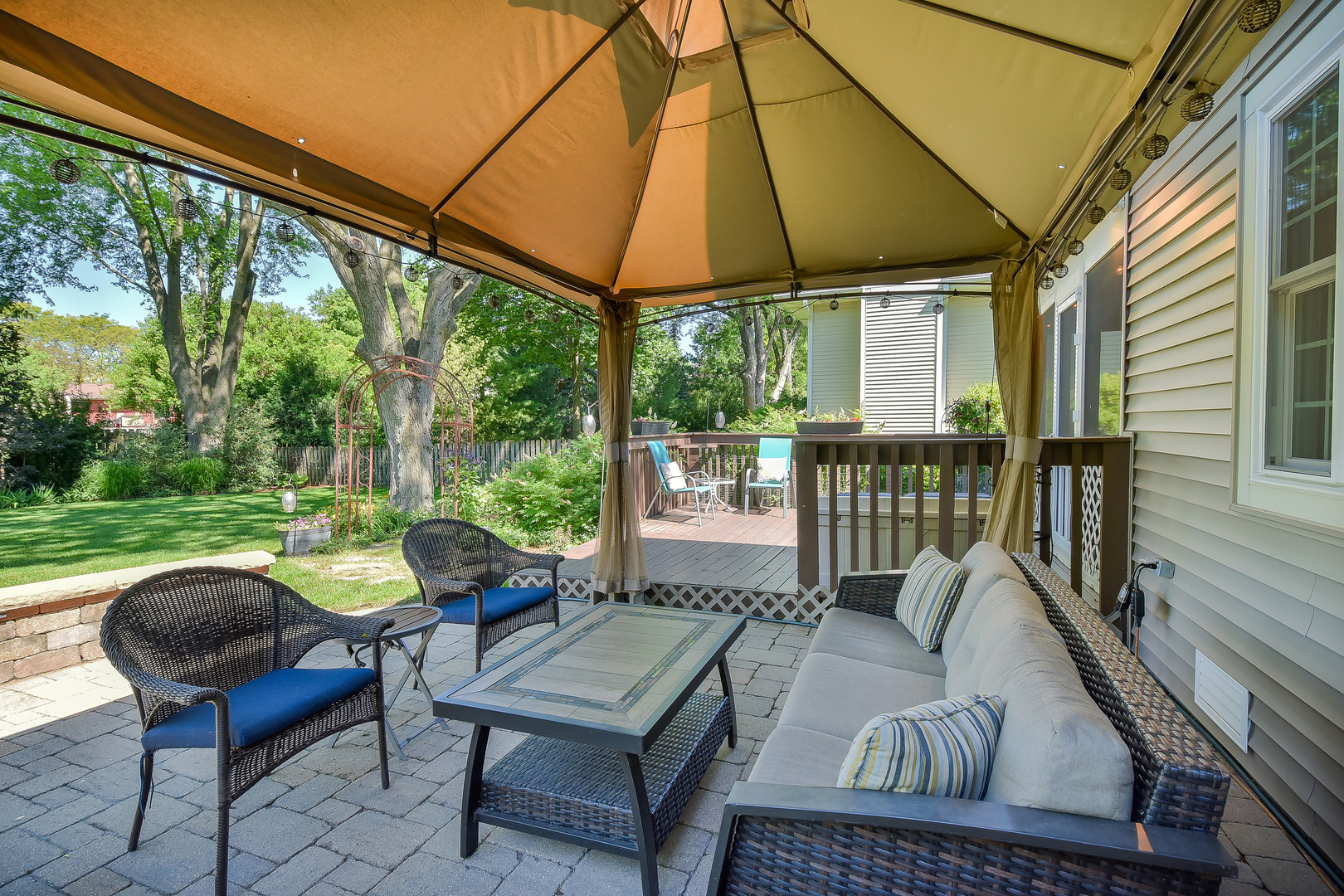 18 Wakefield Lane Geneva, IL 60134 - Photo 21 of 23 a view of a patio with table and chairs under an umbrella