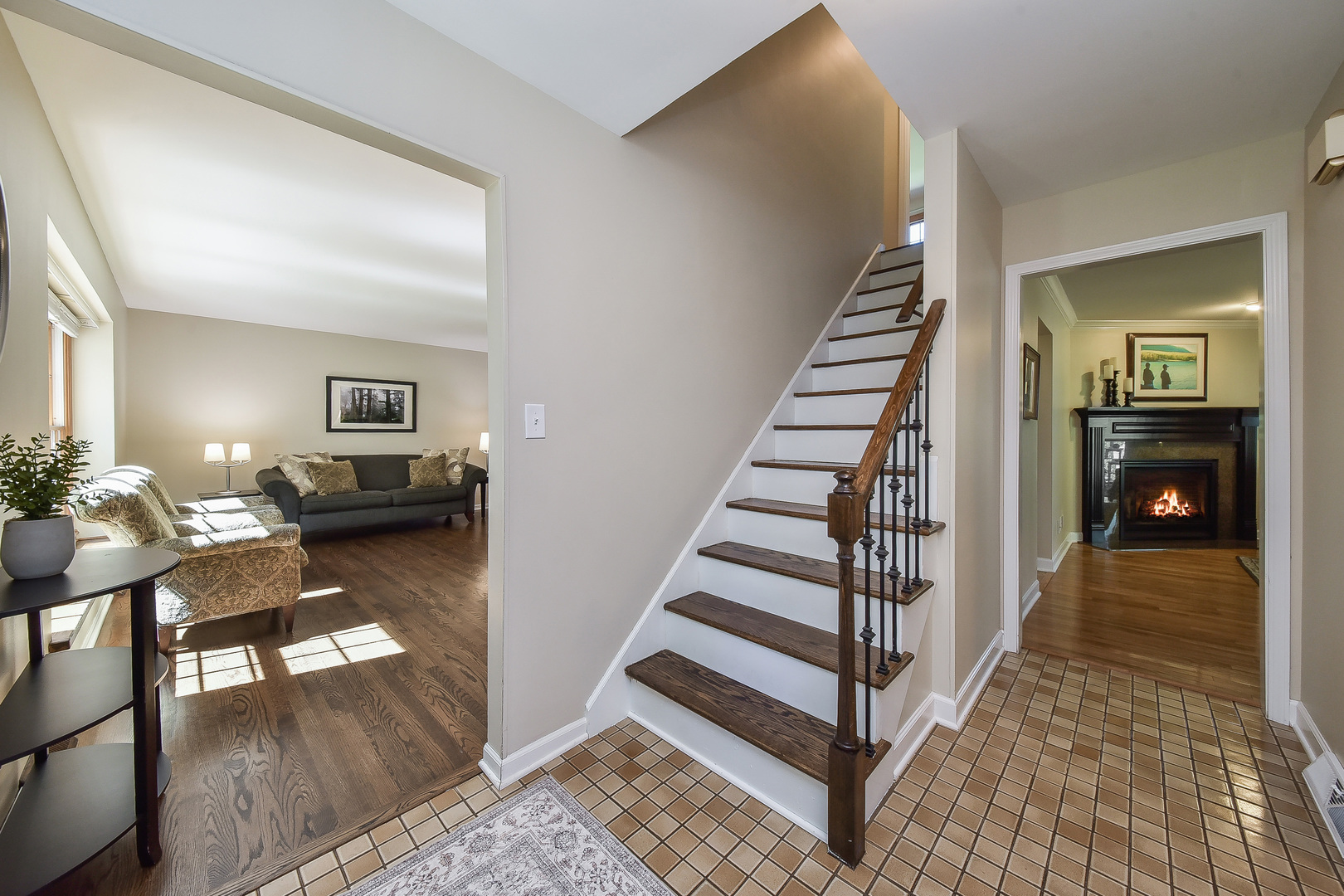 18 Wakefield Lane Geneva, IL 60134 - Photo 3 of 23 a view of a hallway view with wooden floor and dining room view