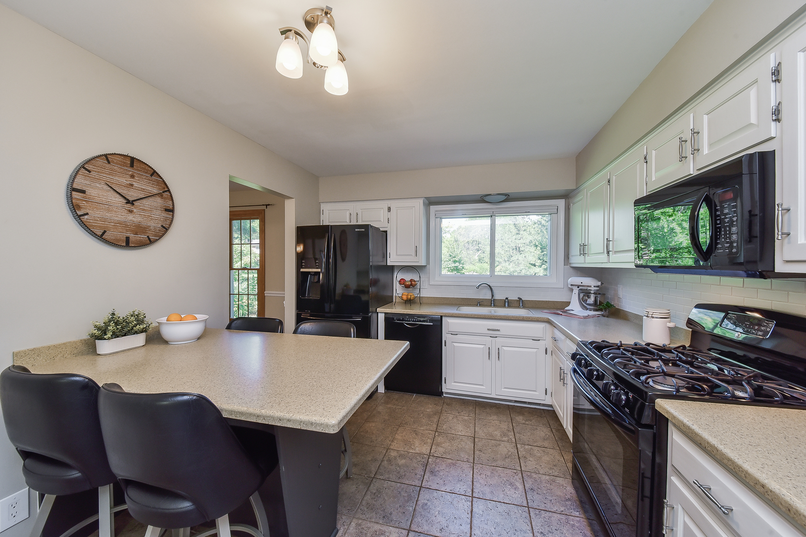 18 Wakefield Lane Geneva, IL 60134 - Photo 7 of 23 a kitchen with a dining table and chairs