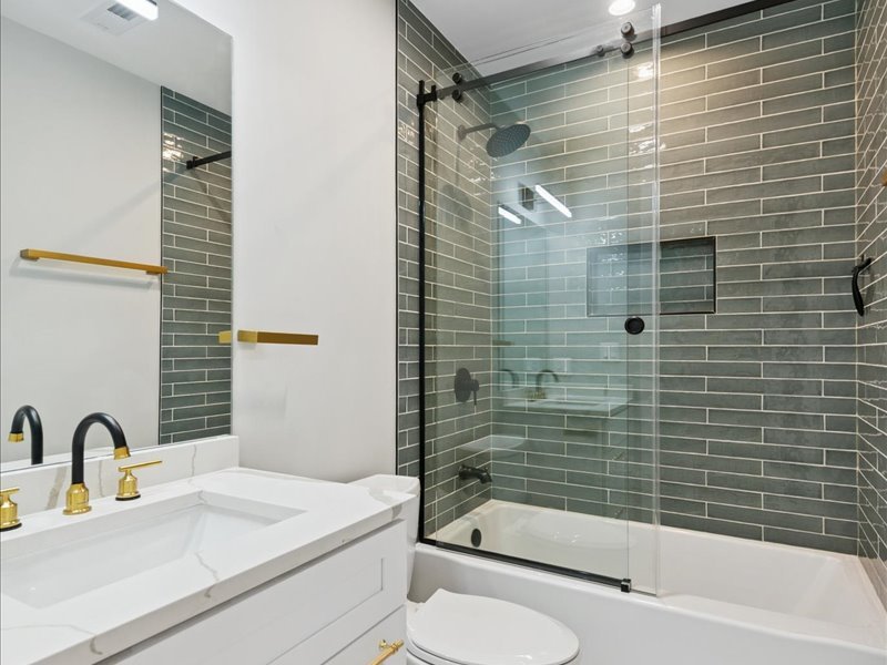 2818 West Fletcher Street, Unit 1 Chicago, IL 60618 - Photo 14 of 18 a bathroom with a sink toilet and shower